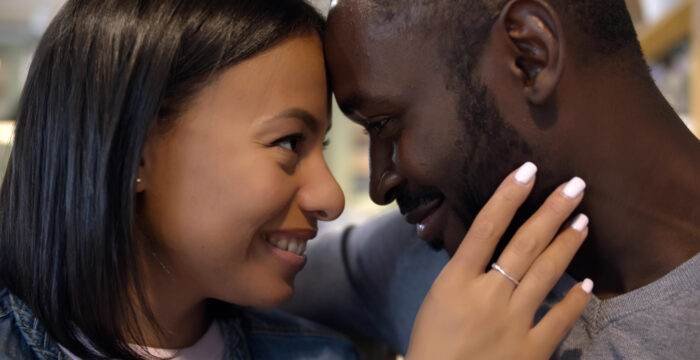 closeup loving mixed race couple embracing smiling