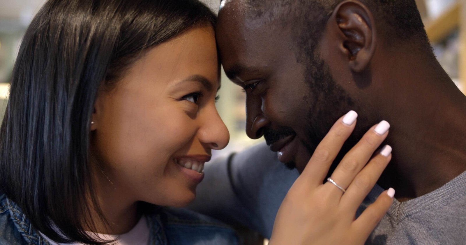 closeup loving mixed race couple embracing smiling scaled