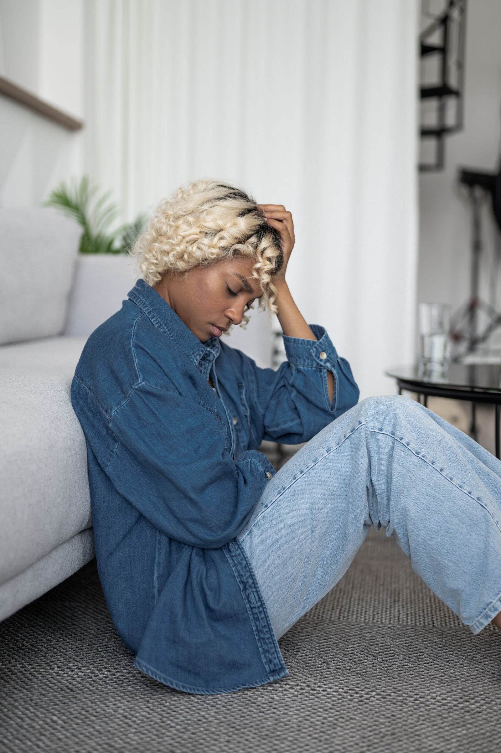 devastated depressed young woman sits with her head her hands mental health issues concept scaled